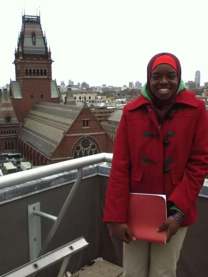 This is a college student in a red coat posing in front of Annenberg Hall.