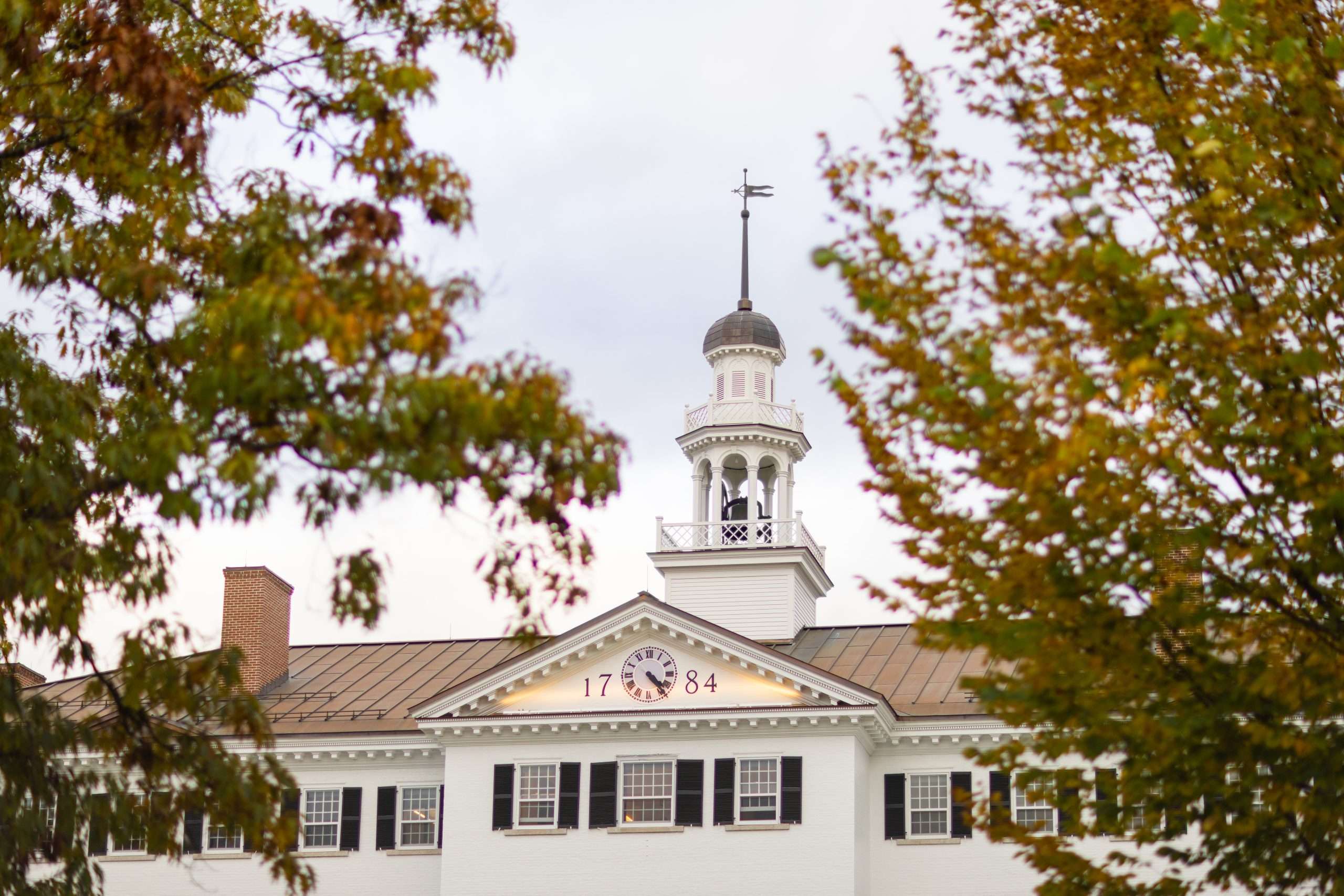 The top of white-bricked Dartmouth Hall is featured, with the year 1784 inscribed.