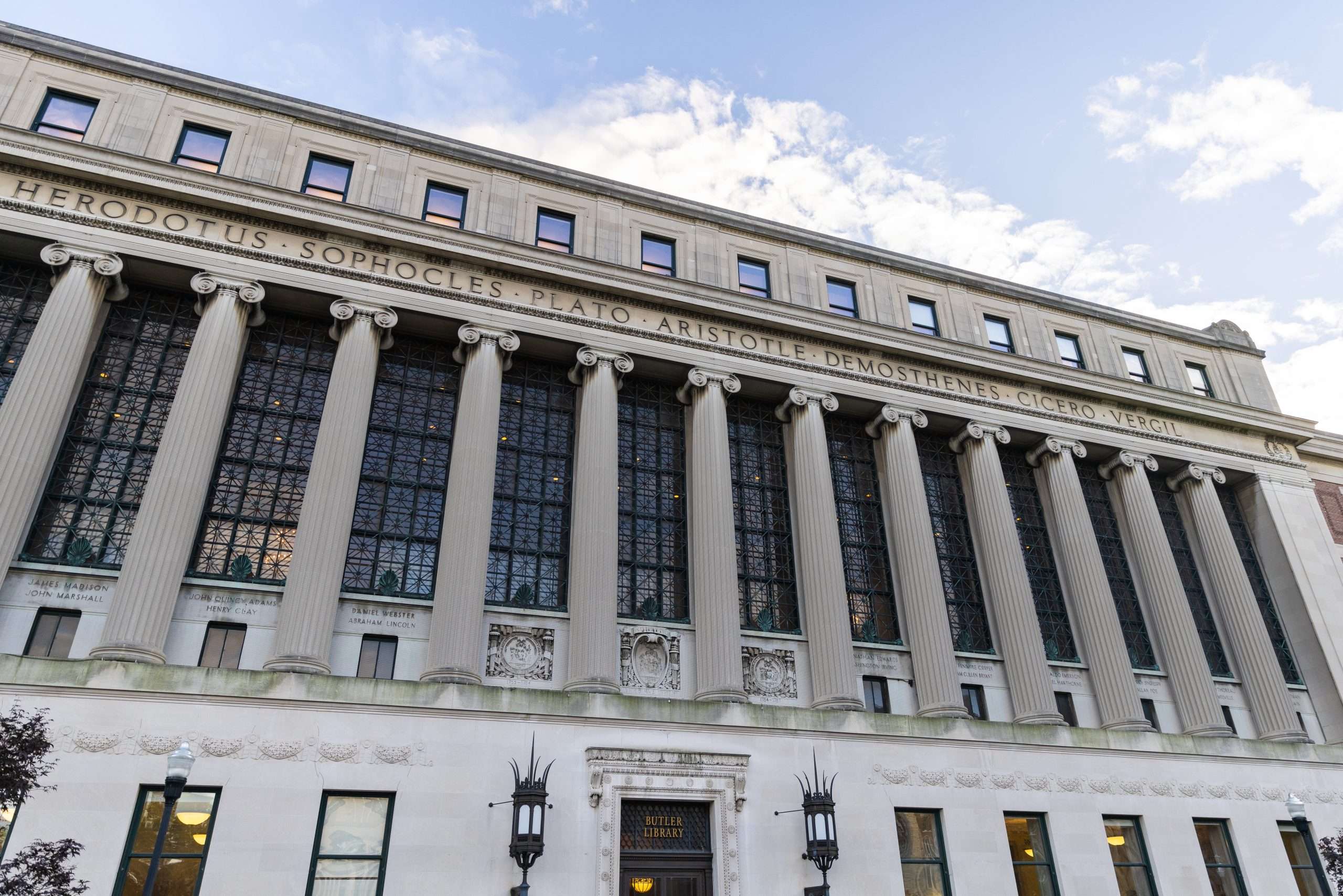 A view from below of the exterior of the columned library at Columbia University.
