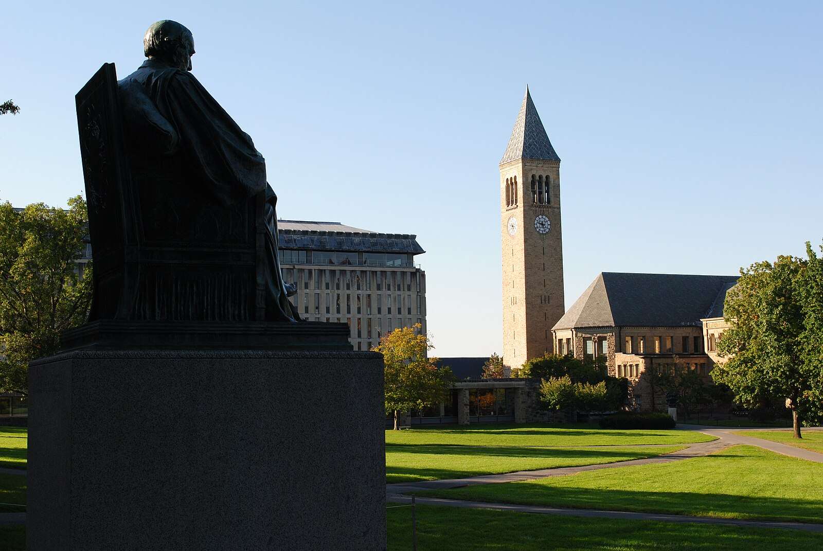 The Cornell Arts Quad is featured beyond a statue.