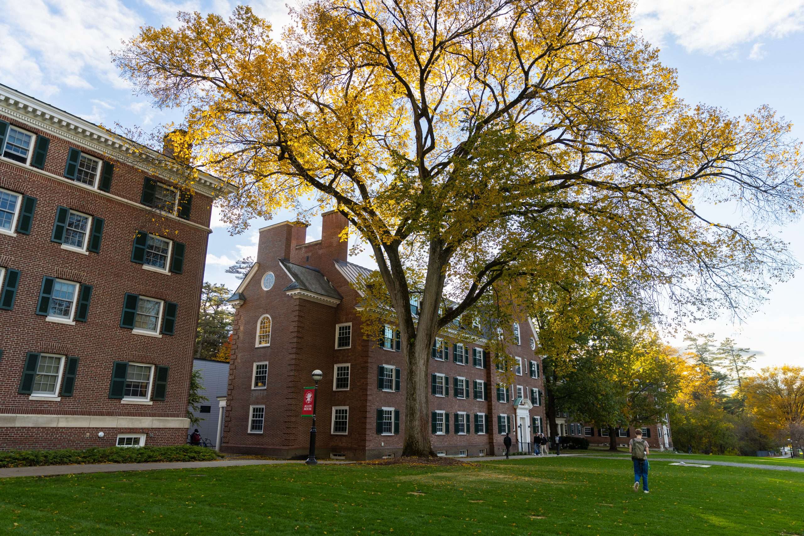 A student walks across The Green at Dartmouth College.