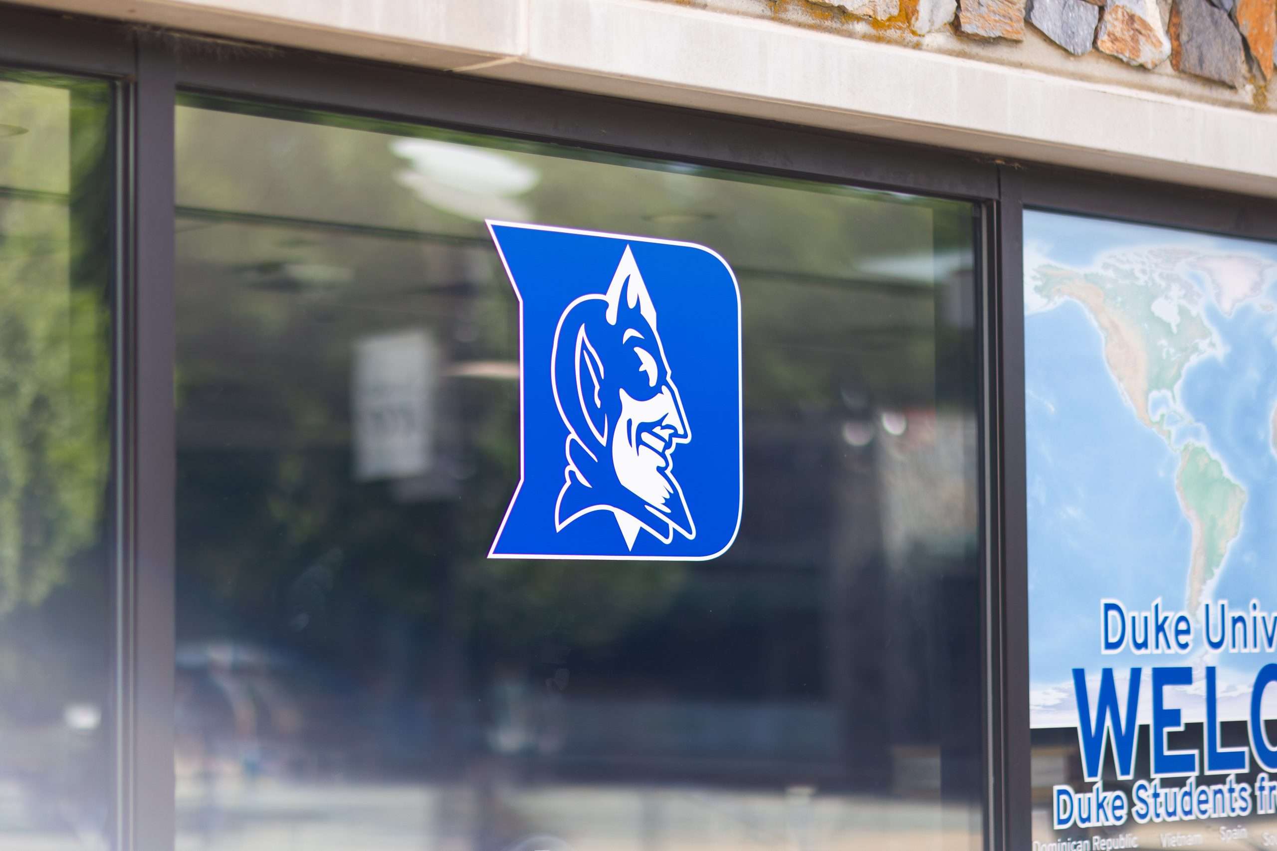 The Duke Blue Devils logo is featured on a window pane.