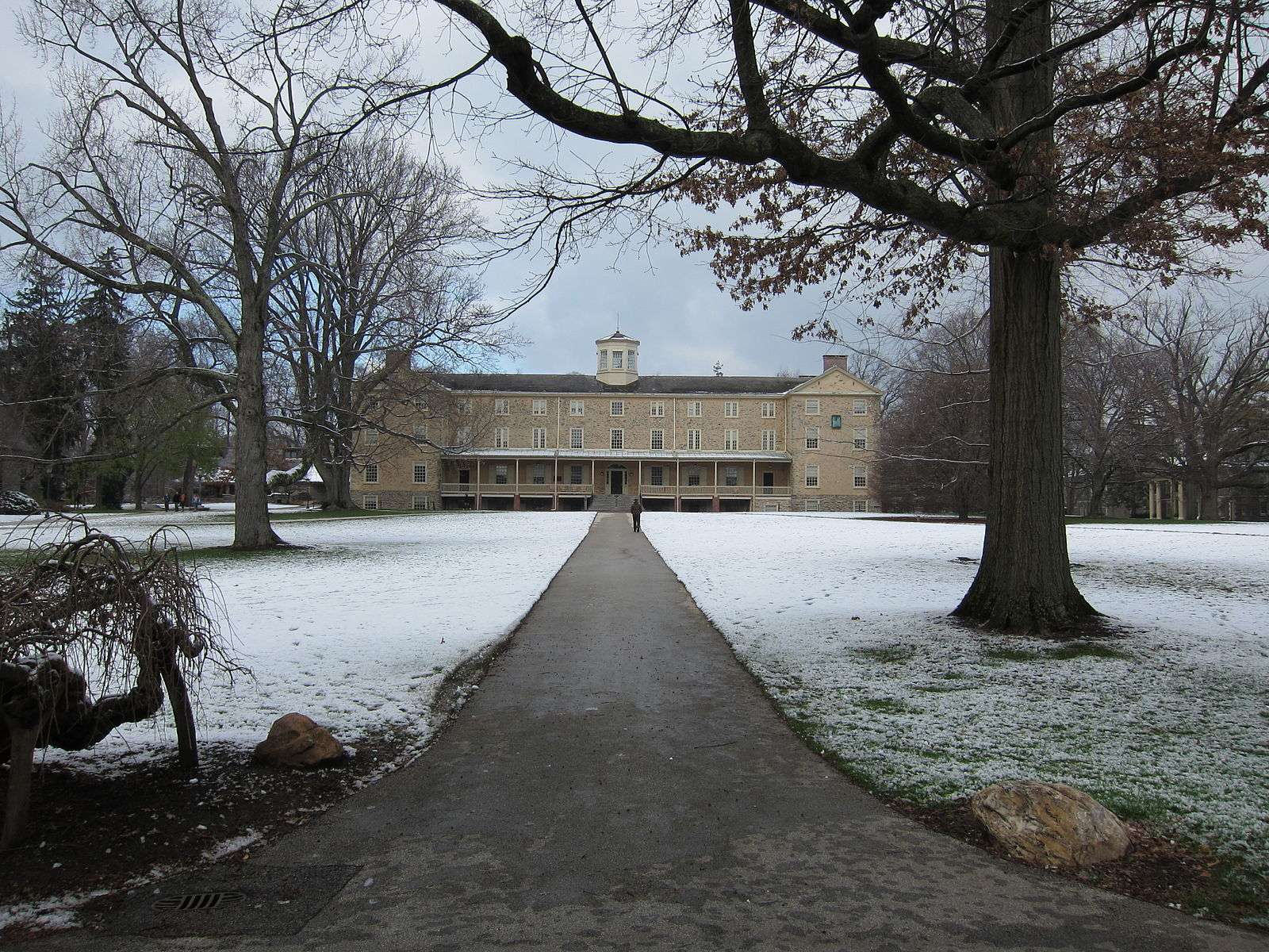 Founders Hall is featured beyond a snow-covered lawn at Haverford College.