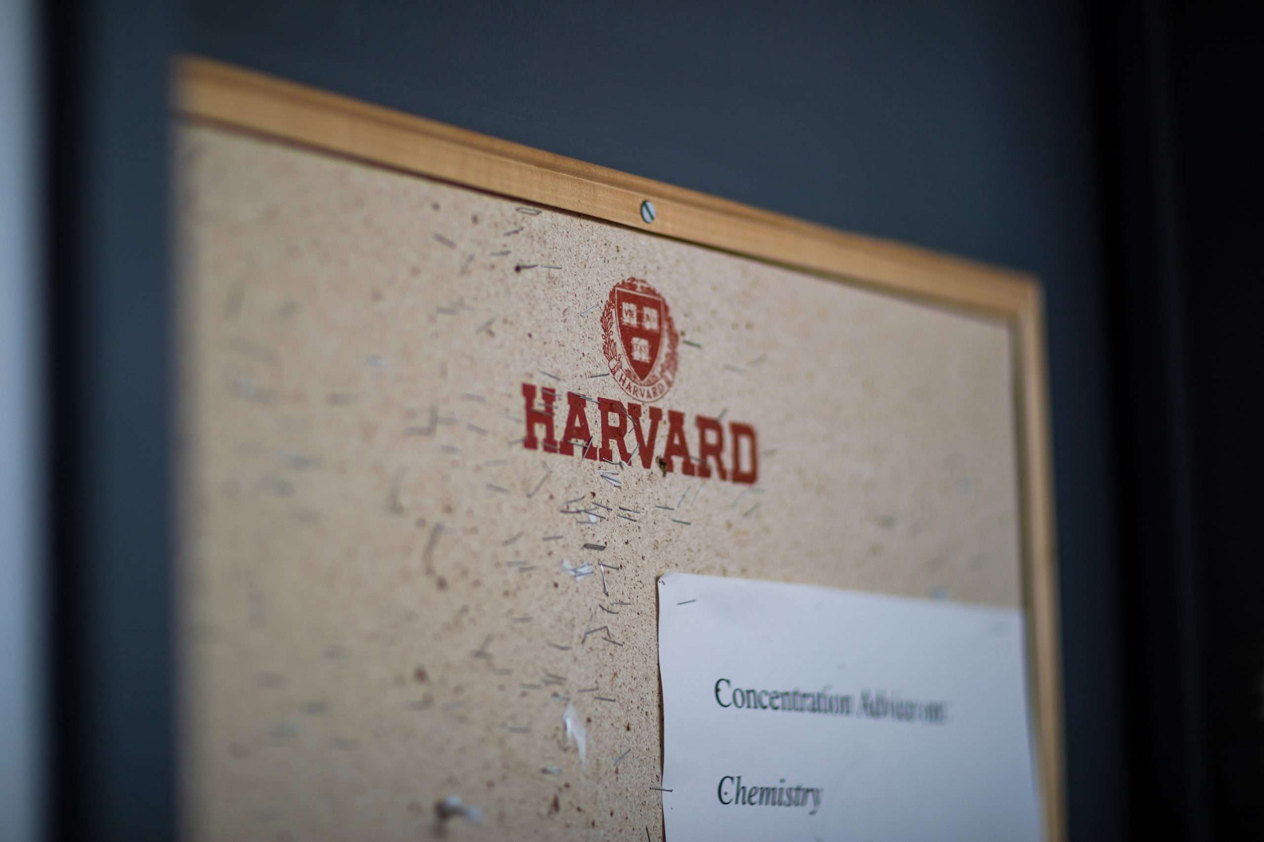 The Harvard logo is featured on a bulletin board.