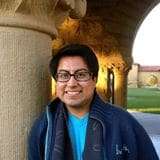 This is a headshot of Marco Medellin next to a column.