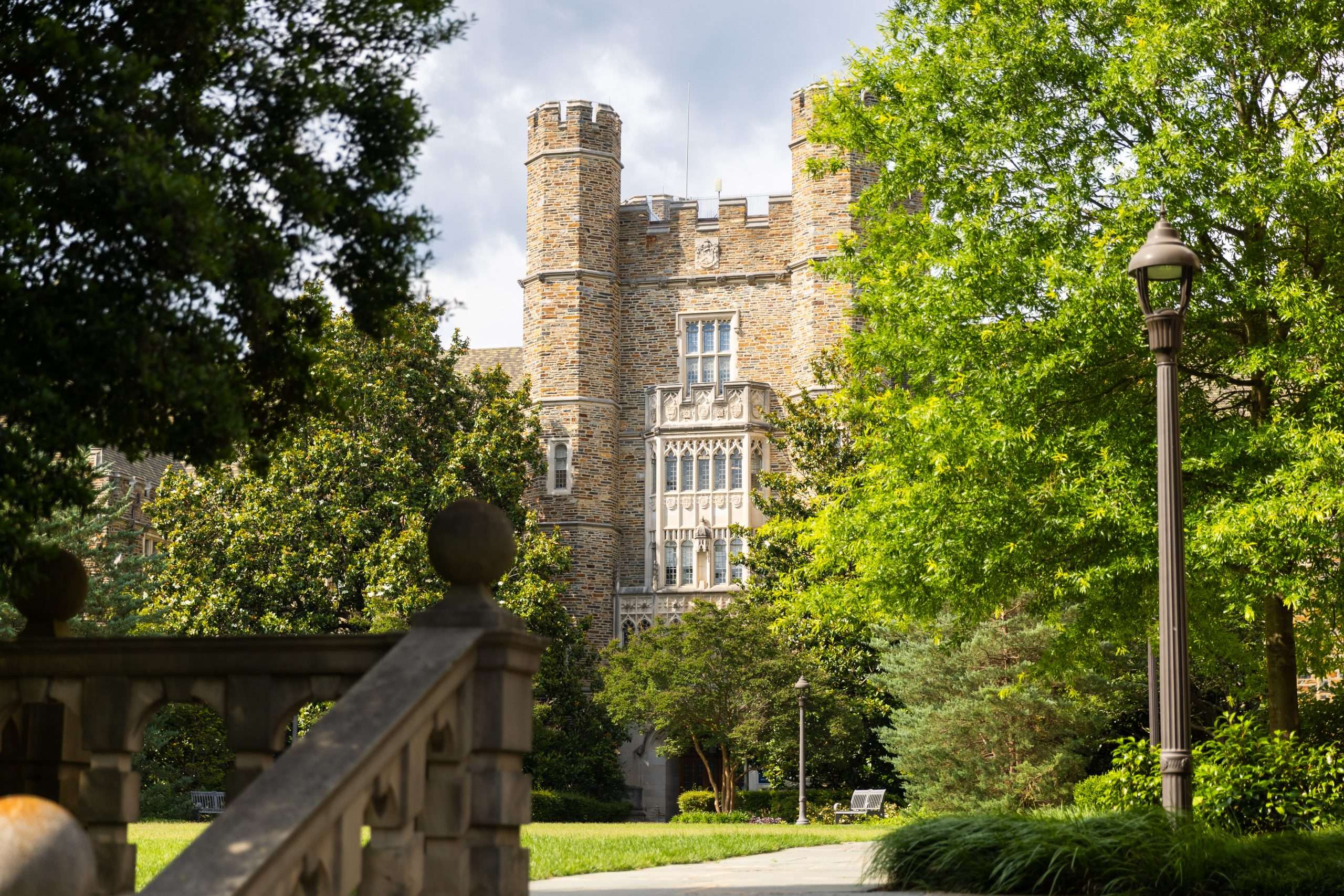 A gothic building is featured beyond a staircase at Duke University.