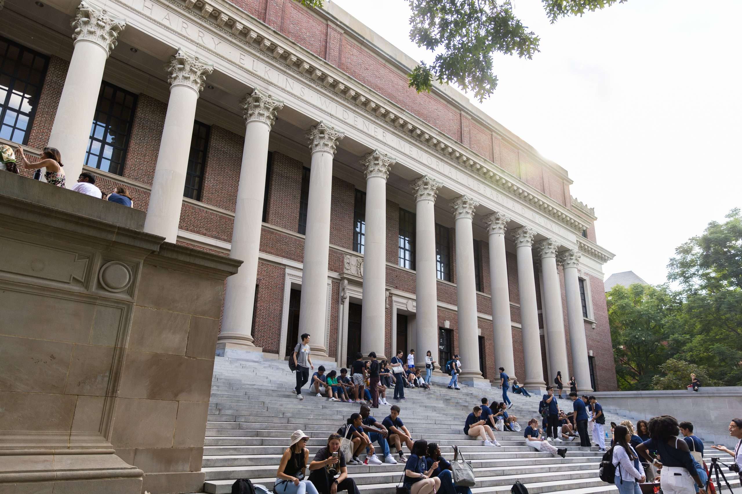 Students sit on the stepf of Widener Library at Harvard University.
